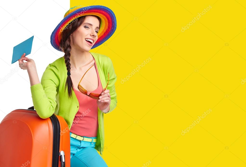 Tourist with travel suitcase and boarding pass