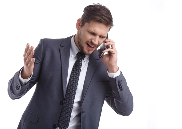 Emotional young man is talking on the phone. The human face, exp — Stock Photo, Image