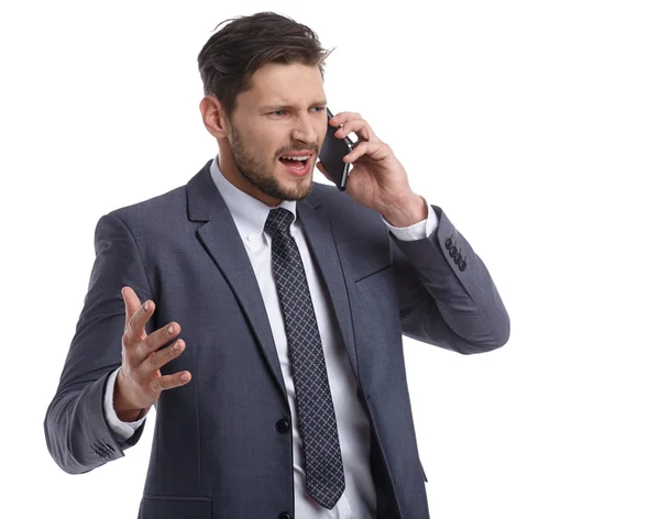 Empresário nervosamente falando ao telefone — Fotografia de Stock