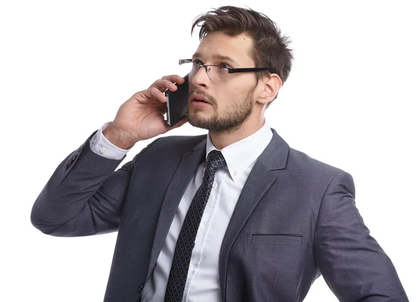 Emotional young man is talking on the phone. The human face, exp — Stock Photo, Image