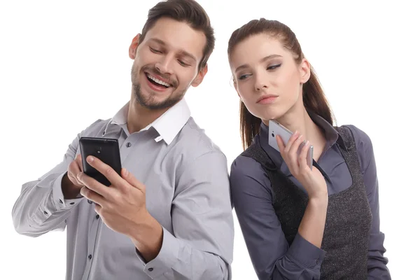 Attractive couple using their smartphones — Stock Photo, Image