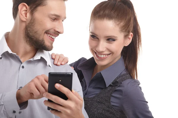 Attractive couple using smartphone — Stock Photo, Image