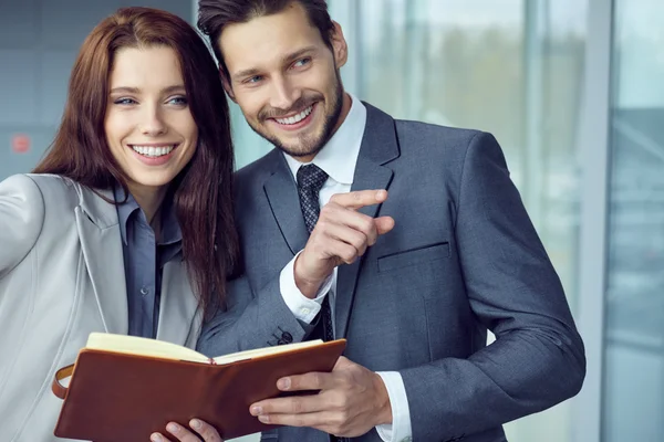 Business couple looking at file indoors — Stock Photo, Image