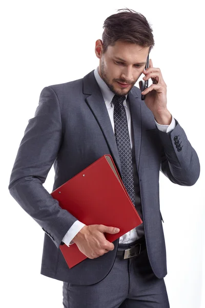 Hombre de negocios con teléfono y carpetas —  Fotos de Stock