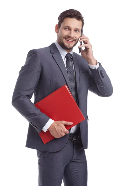 Hombre de negocios con teléfono y carpetas —  Fotos de Stock