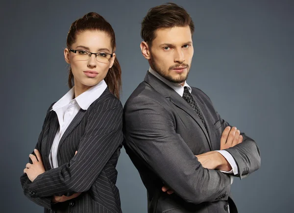 Business couple in suits — Stock Photo, Image