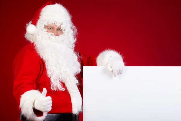 Santa Claus pekar i vit blank — Stockfoto