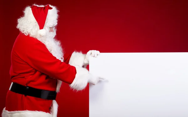 Santa Claus pekar i vit blank — Stockfoto
