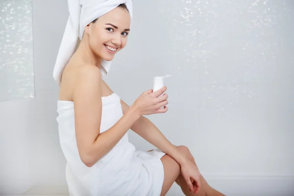 Woman Wrapped with Bath Towels, Applying Cream on her Face — Stock Photo, Image