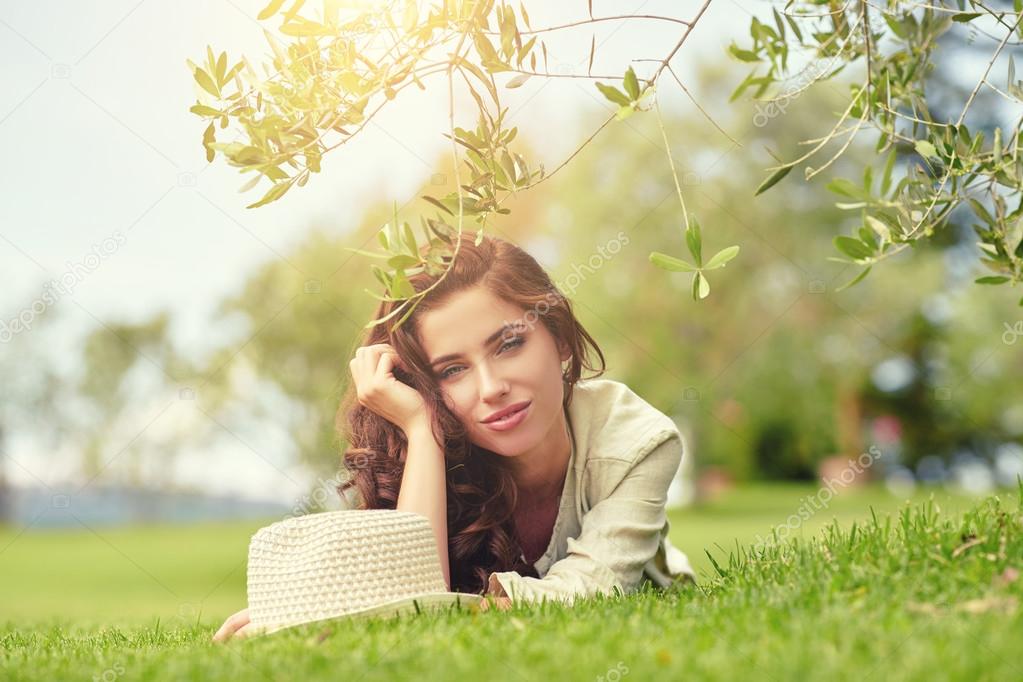 woman lying on grass outdoors