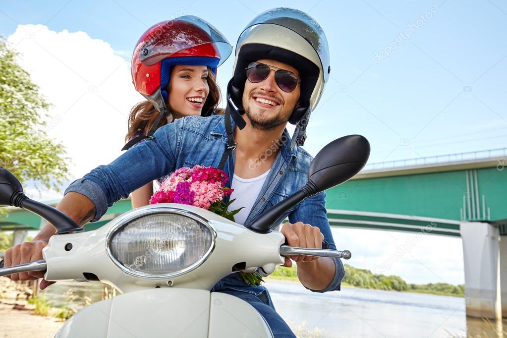 couple on scooter driving together