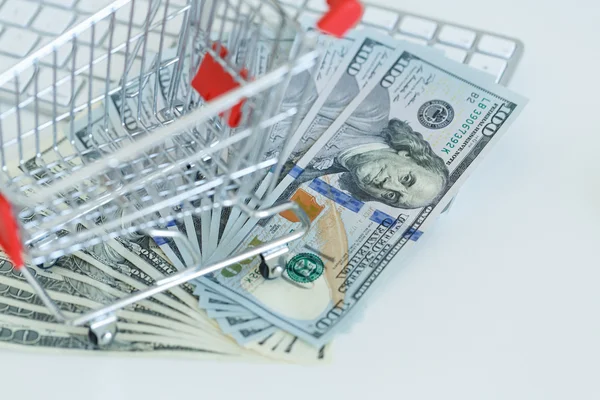 Dollars and shopping cart on a computer keyboard — Stock Photo, Image
