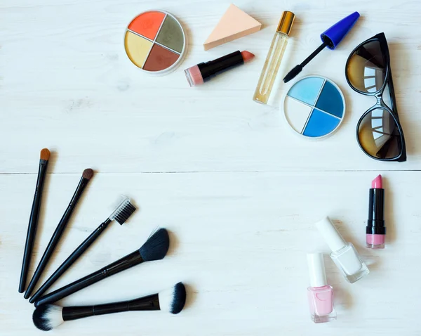 Various makeup products on wooden background with copyspace — Stock Photo, Image