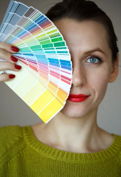 Mujer con labios rojos que busca una paleta de colores — Foto de Stock