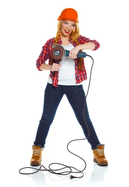 Female construction worker in a hard hat with angle grinder over — Stock Photo, Image