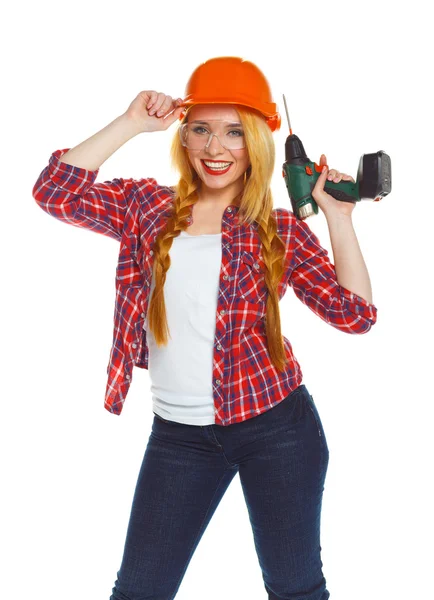 Trabalhadora da construção feminina em um capacete com um perfurador — Fotografia de Stock