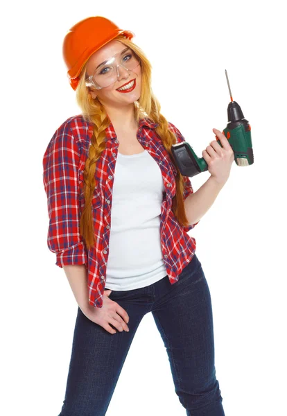 Trabalhadora da construção feminina em um capacete com um perfurador — Fotografia de Stock