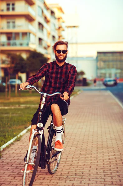 Καλαίσθητο άνθρωπος σε γυαλιά ηλίου, το ποδήλατο στην πόλη δρόμο — Φωτογραφία Αρχείου