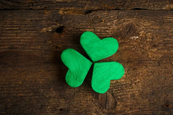 Green shamrock clovers on wooden background — Stock Photo, Image