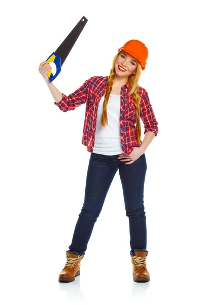Funny woman in helmet with a saw on a white background — Stock Photo, Image