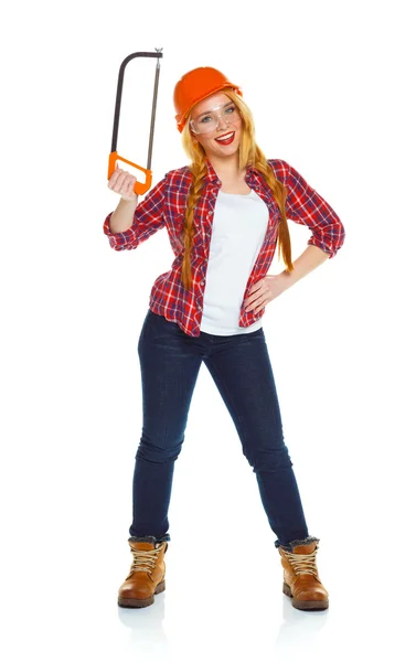 Funny woman in helmet with a saw on a white background — Stock Photo, Image