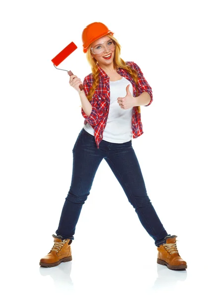 Funny girl in a helmet with roller in hand it is isolated on the — Stock Photo, Image