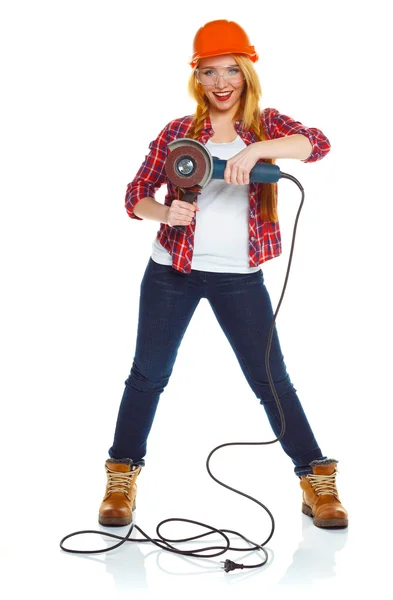 Female construction worker in a hard hat with angle grinder over — Stock Photo, Image