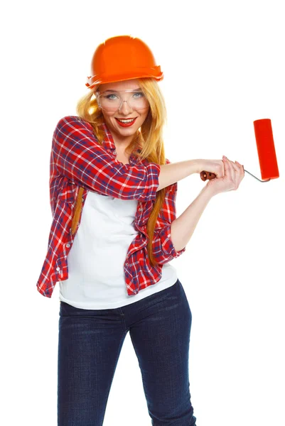 Funny girl in a helmet with roller in hand it is isolated on the — Stock Photo, Image