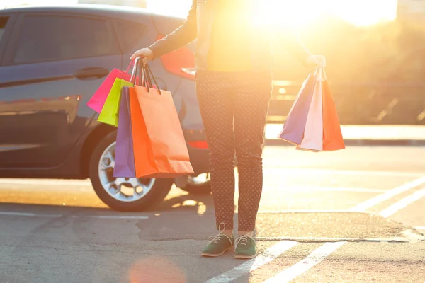 車に彼女の買い物袋をかぶる女 — ストック写真