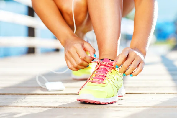 Running shoes - woman tying shoe laces — Stock Photo, Image