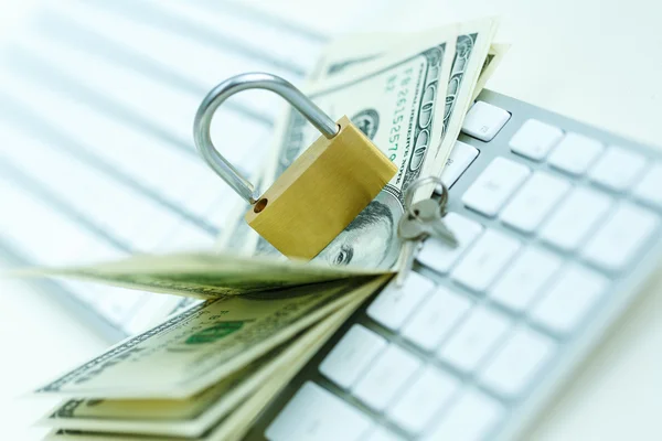 Security lock on dollar bills with white computer keyboard — Stock Photo, Image