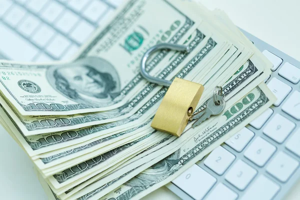 Security lock on dollar bills with white computer keyboard — Stock Photo, Image