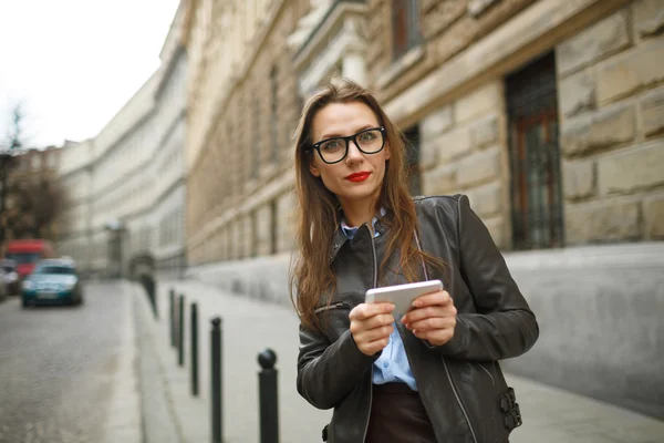 Mujer de negocios caminando por la calle mientras habla en pho inteligente — Foto de Stock