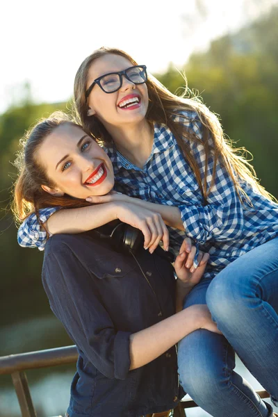 Two playful young women having fun outdoors — Stock Photo, Image