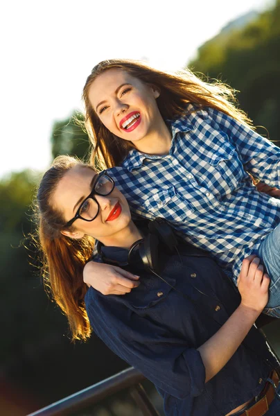 Two playful young women having fun outdoors — Stock Photo, Image