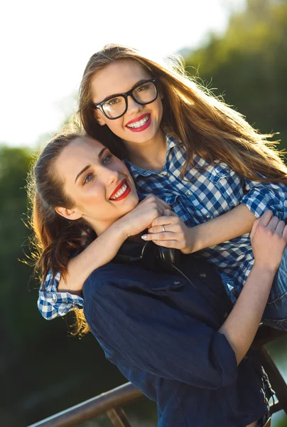 Dos mujeres jóvenes juguetonas divirtiéndose al aire libre — Foto de Stock