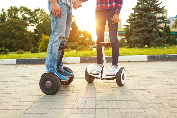 A young couple riding hoverboard - electrical scooter, personal — Stock Photo, Image