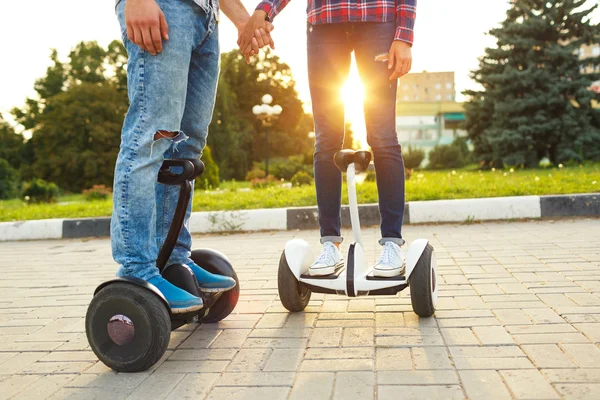 A young couple riding hoverboard - electrical scooter, personal — Stock Photo, Image