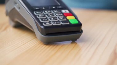 NFC kredi kartı ödemesi. NFC teknolojisiyle kredi kartıyla ödeme yapan bir kadın. Kablosuz para transferi. Kablosuz ödeme