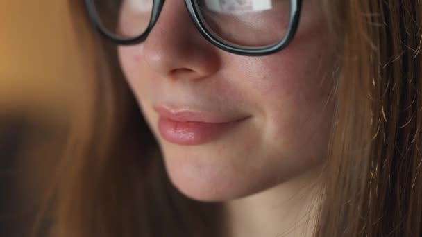 Mujer con gafas mirando en el monitor y navegando por Internet. La pantalla del monitor se refleja en las gafas. Trabaja de noche. Ministerio del Interior. Trabajo remoto — Vídeos de Stock