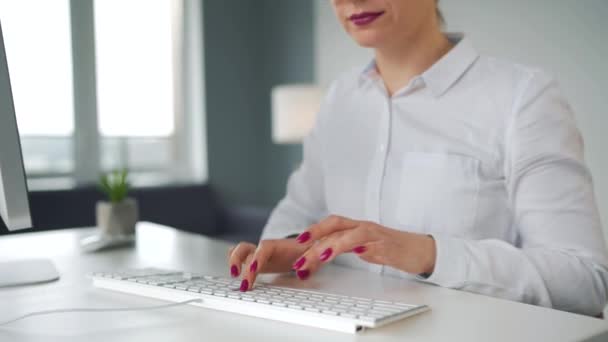 Woman typing on a computer keyboard. Concept of remote work. — Stock Video