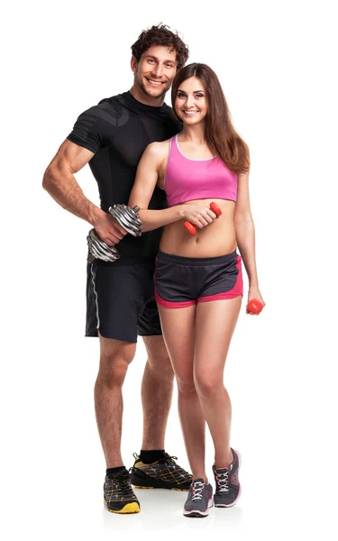 Sportliches Paar - Mann und Frau mit Hanteln auf dem weißen — Stockfoto