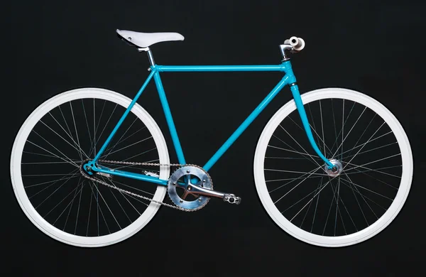 Stylish womens blue bicycle isolated on black — Stock Photo, Image