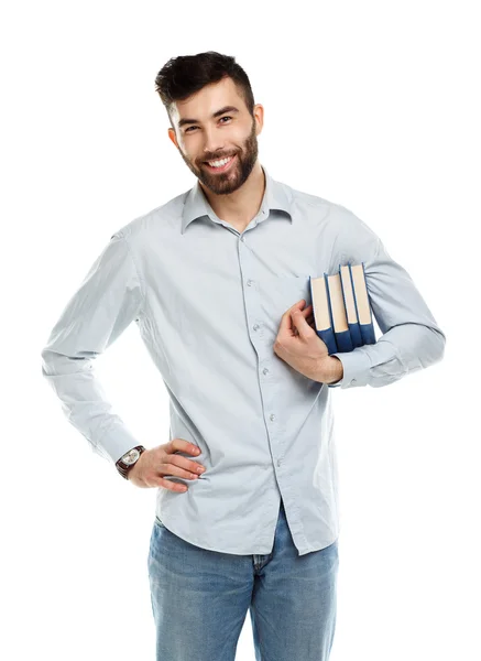 Jong gebaard lachende man met boeken in hand op wit — Stockfoto