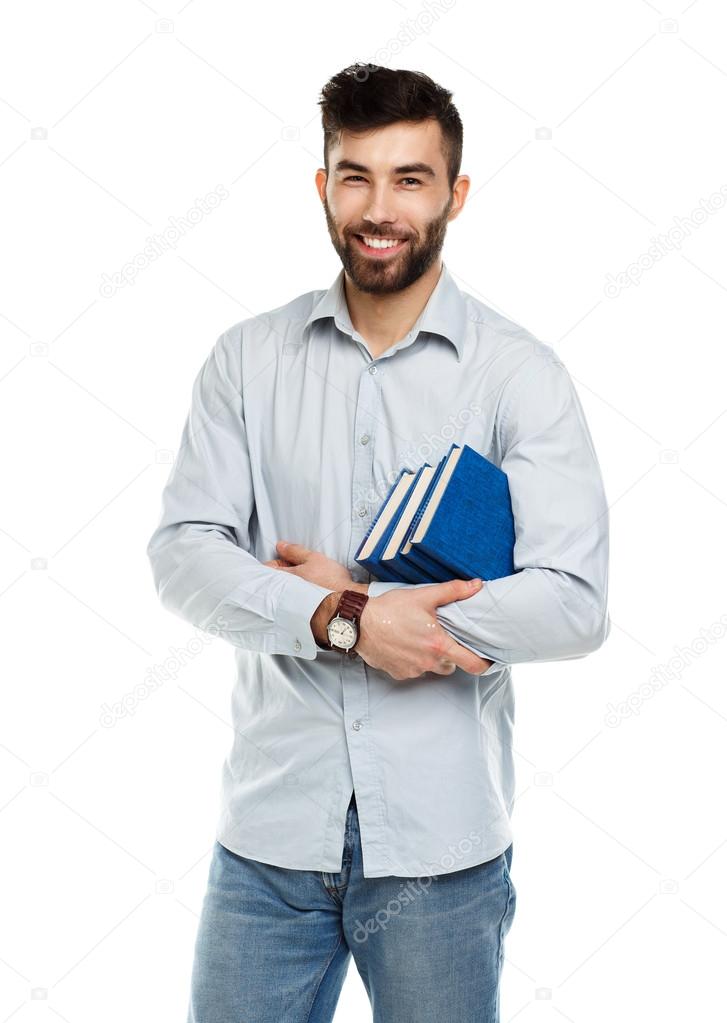 Young bearded smiling man with books in hands on white