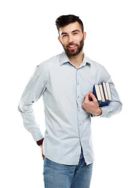 Junger bärtiger lächelnder Mann mit Büchern in der Hand auf weißem Grund — Stockfoto