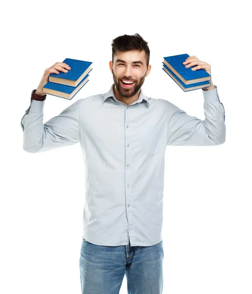 Junger bärtiger lächelnder Mann mit Büchern in der Hand auf weißem Grund — Stockfoto