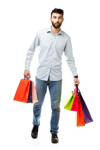 Bonito homem segurando sacos de compras — Fotografia de Stock