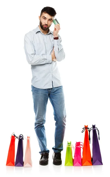 Handsome man with shopping bags and holding credit card — Stock Photo, Image