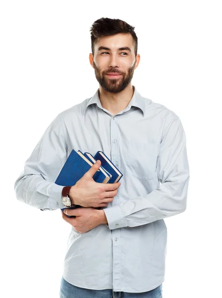 Young bearded smiling man with books in hand on white — Stock Photo, Image